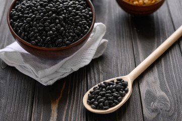 Fresh organic natural beans on wooden rustic black background