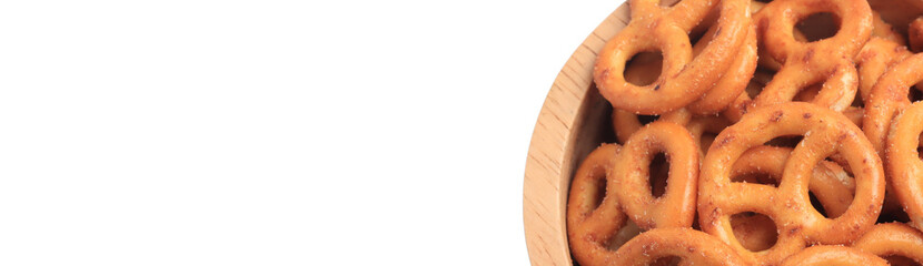 Freshly baked homemade soft pretzel with salt in a wooden cup on white background.copy space