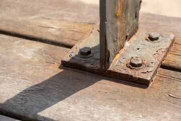 Corrosive rusty bolt close-up. Wood and metal are susceptible to rust