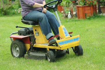 a person mows the grass