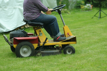 a person mows the grass