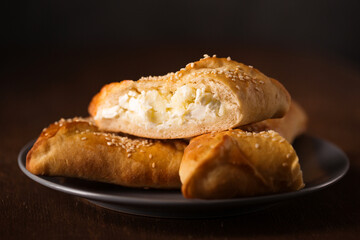 Ruddy cakes with suluguni cheese with sesame seeds on a plate