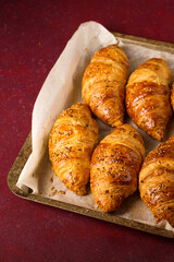 Ruddy crispy croissants on a baking sheet