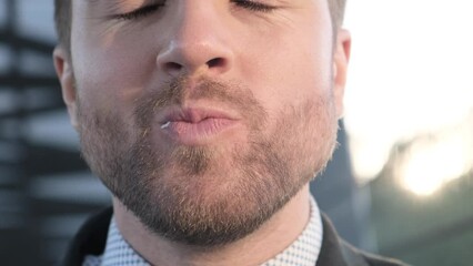 The office manager eats a delicious burger at his lunch break near his office. Concept of junk food