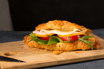 Cooked croissant with ham, cheese and vegetables
