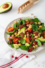 Close up of healthy food vegan avocado salad with greens and chick pea