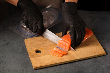 Chef slices salmon