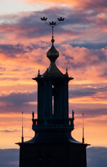 Orange sunset behind the tower of the city hall of Stockholm