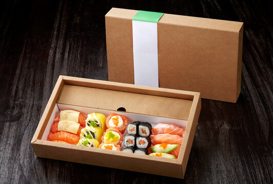 A delicious combination of Japanese sushi dishes ,in a paper takeaway package