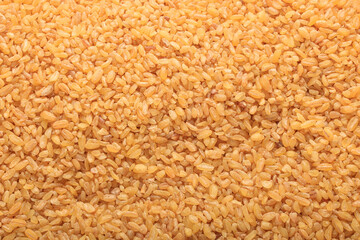 Raw bulgur food background. Dry bulgur grain. Healthy eating. Organic product. Top view.