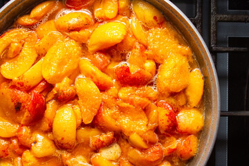 Preparation of apricot jam. Pieces of apricots in syrup. Sweet fruit dessert
