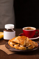 croissant with peanut butter, banana and coffee