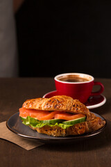 croissant with salmon and coffee