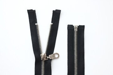 Open metal zippers for clothing on white background