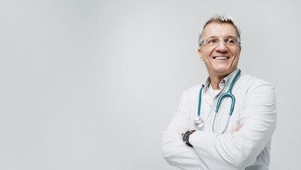 Old male doctor shows smiling in uniform