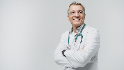 An old male doctor with glasses shows smiling in uniform