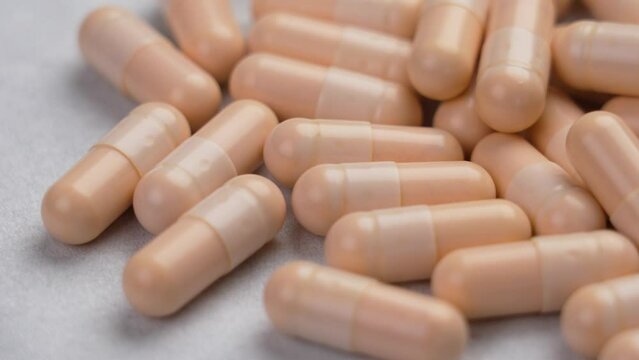 Vitamin B capsules close-up on a white paper napkin close up. Rotation