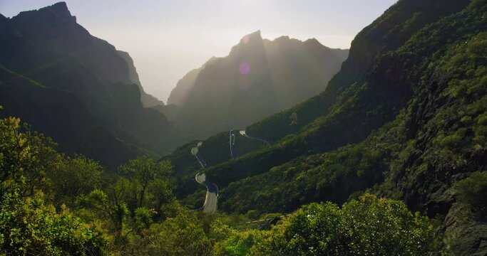 Beautiful Sunset in Masca Valley and Gorge, Tenerife, Canarian Islands, Spain. Sunlight breaks through the mountain ranges. Amazing view.