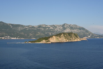 Naklejka premium View from the sea. Large sea surface with numerous rocky islands. Mediterranean Blue Sea in Montenegro. Mountain Islands of Montenegro.
