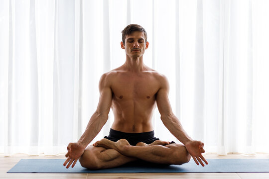 Athletic Strong Man Practicing Difficult Yoga Pose. Stock Photo - Image of  vitality, soul: 79003714