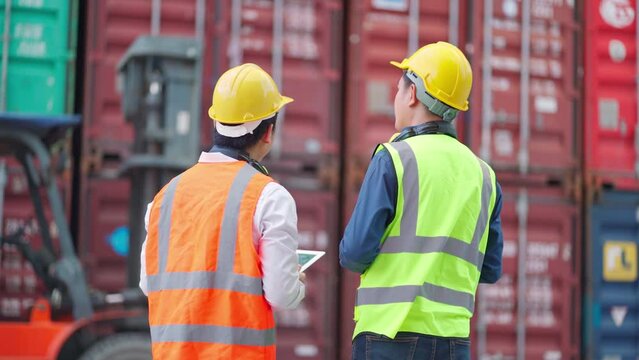 Dock manager and engineer worker discuss on project with smile in shipping container yard. Import and export product. Manufacturing transportation and global business concept. Successful on project 