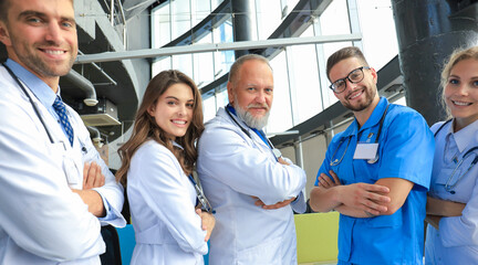 Group of happy doctors in hospital corridor, portrait.