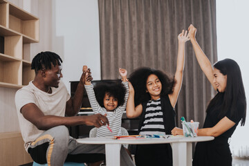 Happy family having fun time at home. African family playing together in living room at home. Happy family concept.