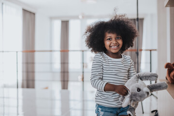 African kids playing with her family in living room. African kid daughter have fun and laughing with family. Happy family time.