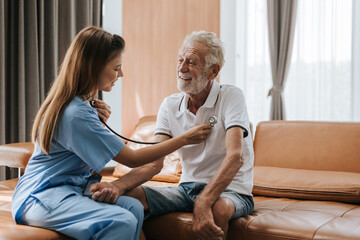 Young nurse caring elderly man at home. asian nurse helping senior man at home. Senior health care.