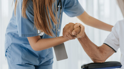 Nurse hand to helping and support senior man. Young nurse and Elderly man hands to support together. Helping hands, care for the elderly concept. - obrazy, fototapety, plakaty