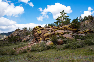 rocks covered with forest against the blue sky in the area of the Merkit fortress