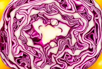 Red cabbage background. Close-up of red cabbage in cut with yellow tomatoes on sides Selective focus