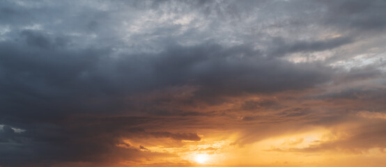Fototapeta na wymiar Dramatic sunset with dark stormy clouds