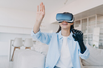 Handicapped girl gets rehabilitation in vr glasses. Amputee with bionic limb prosthesis.