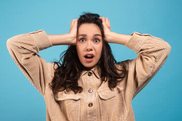 Afraid frightened millennial caucasian lady brunette student in casual with open mouth holding her...