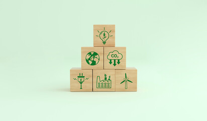 Alternative energies to save the planet. Carbon footprint ecological symbols on a wooden cube....