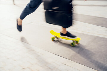 Blurred in motion photo, a man on a skateboard goes to the office