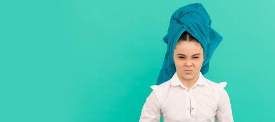 Close up face of kid girl, facial treatment, child in towel after shower. young girl on blue...