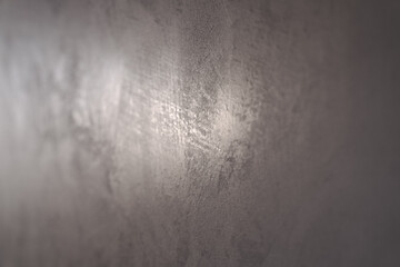 Angle shot of decorative plaster wall with reflection of the light