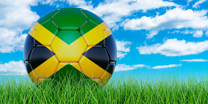 Soccer ball with Jamaican flag on the green grass against blue sky, 3D rendering