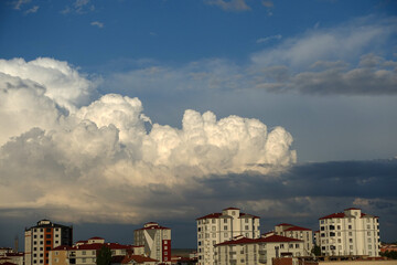 Fototapeta premium cumulus clouds,puffy clouds,heaped white cloud cluster,city and big clouds.