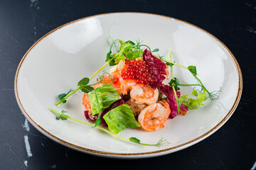 Salad from shrimp tails with lettuce, arugula, cherry tomatoes, avocado, olive oil and balsamic vinegar.