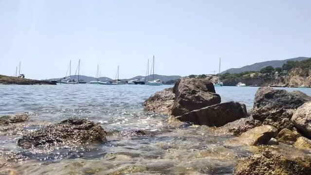 Sea waves on rocky shore. Seascape. Tourist destination at Majorca. Playa de Illetas, Majorca, Balearic Islands, Spain