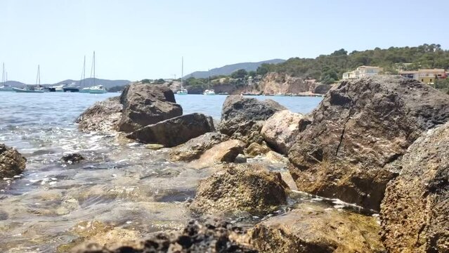 Sea waves on rocky shore. Tourist destination at sea. Playa de Illetas, Majorca, Balearic Islands, Spain 