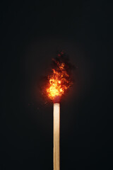 A matchstick set against a dark background with fire effect created in photoshop. Copy space...