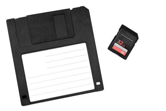 retro floppy disk and modern memory card in black on white background