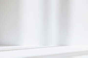Abstract white studio background for product presentation. Empty room with shadows of window....