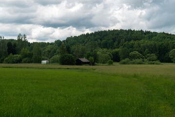 Fototapeta na wymiar Mountains And Old Wooden Barn In The Field