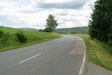Fototapeta na wymiar Asphalt road leading to the village. Bavaria, Germany.