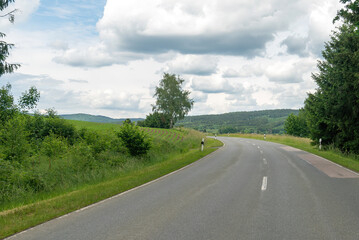 Asphalt road leading to the village. Bavaria, Germany.